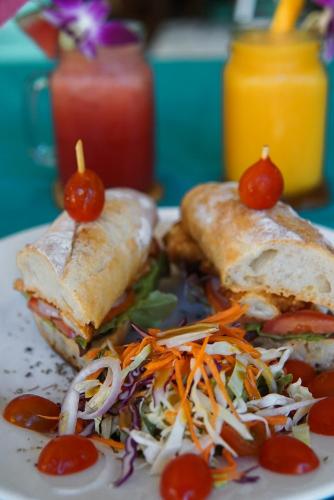 a plate of food with a sandwich and a salad at Baan Kiao in Haad Yao