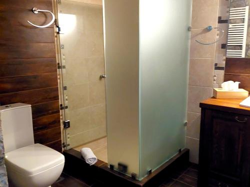 a bathroom with a toilet and a glass shower at PS House Polydrosos - PS Rental in Polydrossos