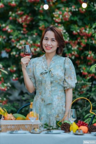 a woman holding up a glass of wine at Tuan Nam Homestay in Ninh Binh