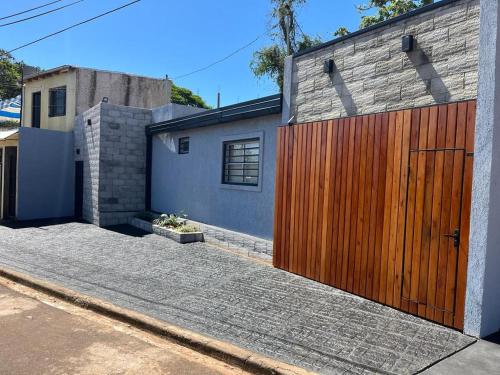 a house with a wooden gate on a street at Avalon Apartments in Puerto Iguazú