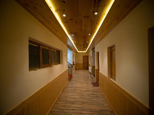 a hallway of an empty building with a wooden ceiling at Siala Guest House in Leh