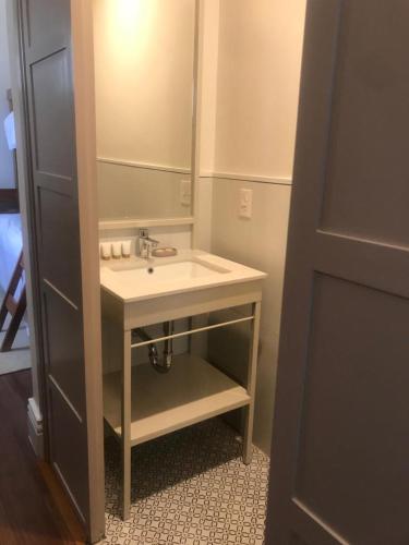 a bathroom with a sink and a mirror at Plaza Central in Arequipa