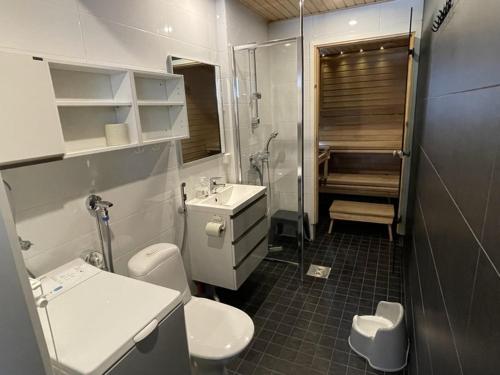 a bathroom with two toilets and a sink and a shower at Syötteenolo in Syöte