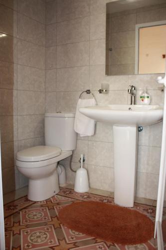 a bathroom with a toilet and a sink at VERTICAL CLIMBING MALTA in Qrendi