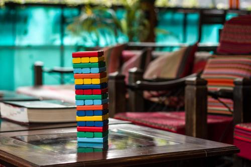 a stack of colored legos on a table with chairs at Nativus Hostel Machu Picchu in Machu Picchu