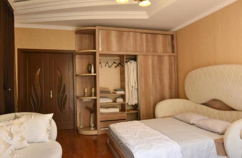 a bedroom with two beds and a book shelf at Apartment Elizabeth in Old Tbilisi in Tbilisi City