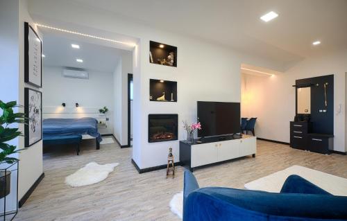 a living room with a bed and a fireplace at Monos Apartman in Tatabánya