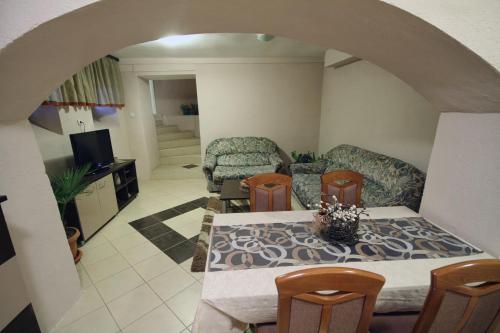 a living room with a table and chairs at Guest House Via in Bitola