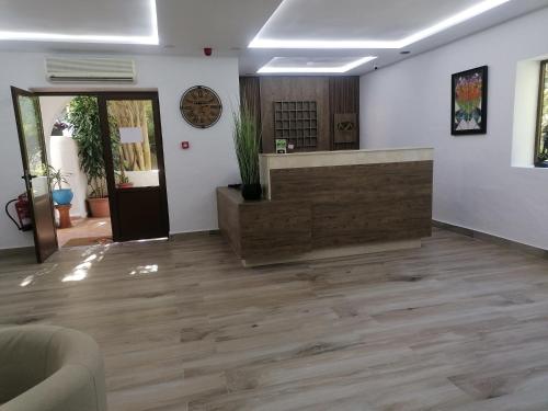 an office with a reception desk and wooden floors at Hôtel Mandy in Tetouan