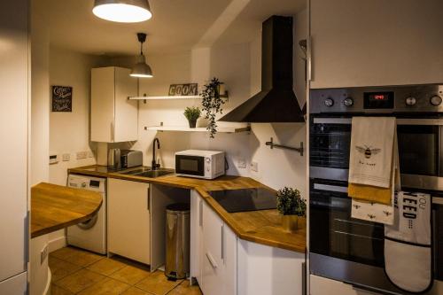 a kitchen with a sink and a stove top oven at Tower Square House in Alloa
