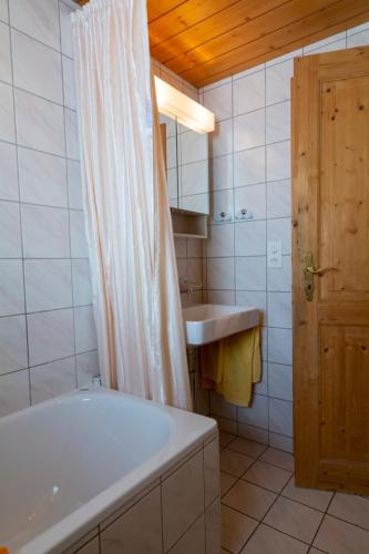 a bathroom with a bath tub and a sink at Chalet Weisshorn 4 in Bettmeralp