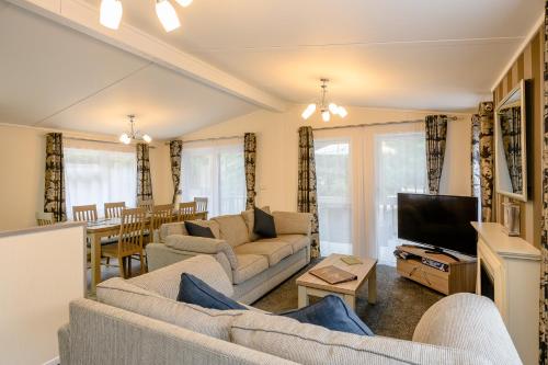 a living room with two couches and a television at Woolverstone Marina and Lodge Park in Ipswich