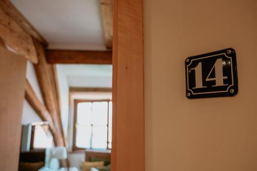 a clock on a wall with the number on it at Bayerischer Hof Spalt in Spalt