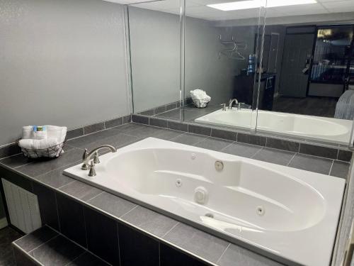 a large white bath tub in a bathroom at Lake Norfork Resort in Henderson