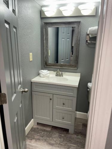 a bathroom with a sink and a mirror at Lake Norfork Resort in Henderson