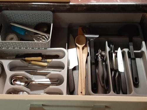a drawer filled with cooking utensils in a kitchen at Huge Garden House for Contractors and Families in Ollerton