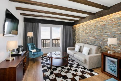 a living room with a couch and a table at Melia Sierra Nevada in Sierra Nevada