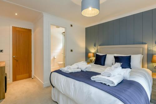 a bedroom with a large bed with towels on it at Woolverstone Marina and Lodge Park in Ipswich