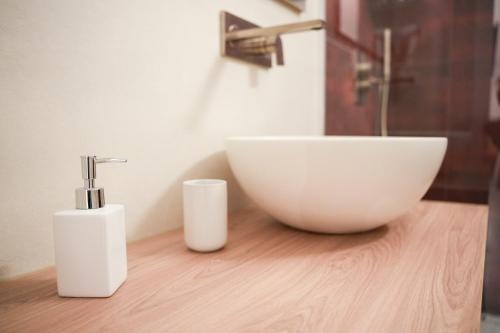 a bathroom with a sink and a bowl on a wooden counter at Dimora dei Celestini in Manfredonia