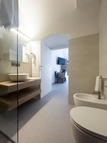 a bathroom with a toilet and a sink at Dimora dei Celestini in Manfredonia