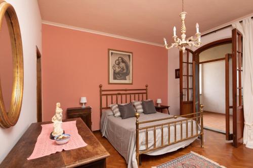 a bedroom with a bed and a table at Exclusive 1970s villa with pool and garden by VacaVilla in Montefalcone