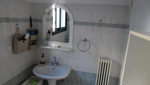 a bathroom with a sink and a mirror at ΜΑΝΑΒΙΚΑ in Tríkala