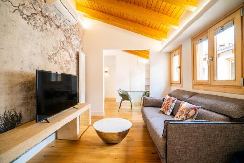 ein Wohnzimmer mit Couch und Flachbildfernseher in der Unterkunft Smartr Madrid Gran Via Apartments in Madrid