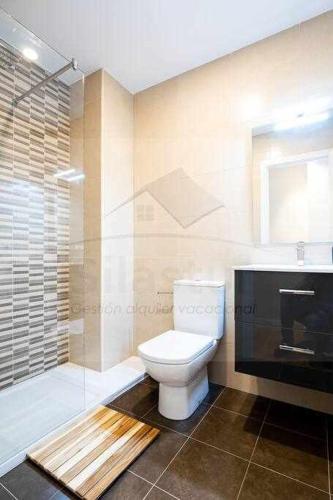 a bathroom with a toilet and a glass shower at I&I By Silastur in Ribadesella