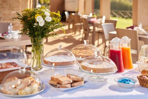 a table with several trays of food on it at Country House Ca'Balsomino in Urbino