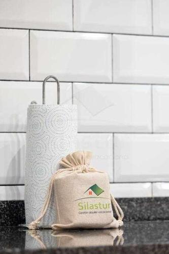 a bag sitting on a counter next to a roll of toilet paper at Lavaderu Apartamento in Gijón