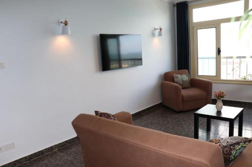 a living room with a couch and a chair at Nour 1 in Alexandria