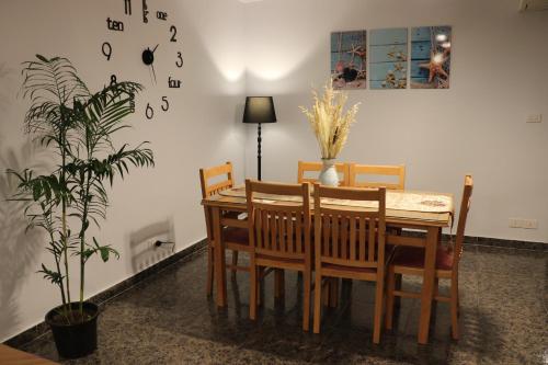 a dining room with a table and a potted plant at Nour 1 in Alexandria