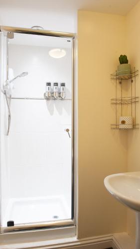 a bathroom with a shower and a sink at The Ramblers' Rest - Princetown in Princetown
