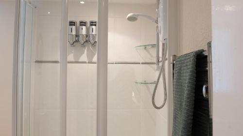 a shower with a glass door in a bathroom at The Ramblers' Rest - Princetown in Princetown