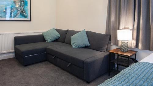a living room with a couch and a bed at The Ramblers' Rest - Princetown in Princetown