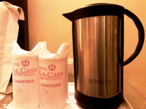 a coffee pot and two milk cartons on a counter at La Casa in Haridwār