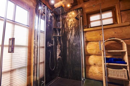 a bathroom with a shower in a log cabin at EifelBlockHaus in Rieden