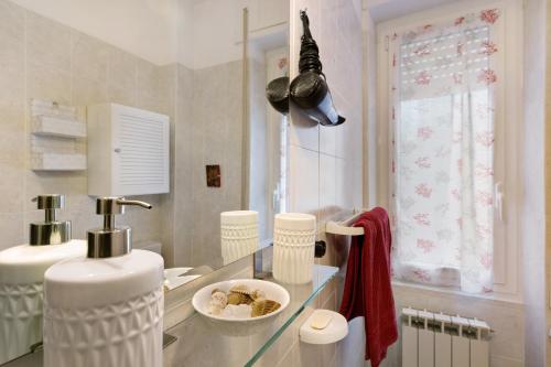 a kitchen with a glass counter top and a sink at Casa Rosso Melograno in Alassio