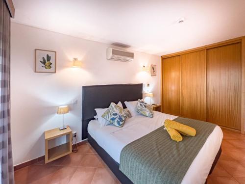 a bedroom with a large bed and a night stand at VilaFoia in Monchique