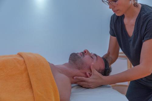 a woman is giving a man a massage at VilaFoia in Monchique