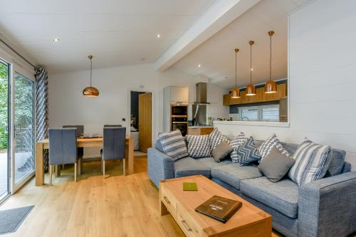 a living room with a couch and a table at Woolverstone Marina and Lodge Park in Ipswich
