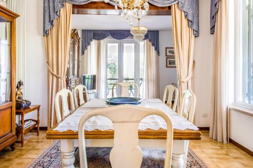 comedor con mesa y sillas en Villa Carini with 3000 mq garden & heated pool, en Castelnuovo del Garda