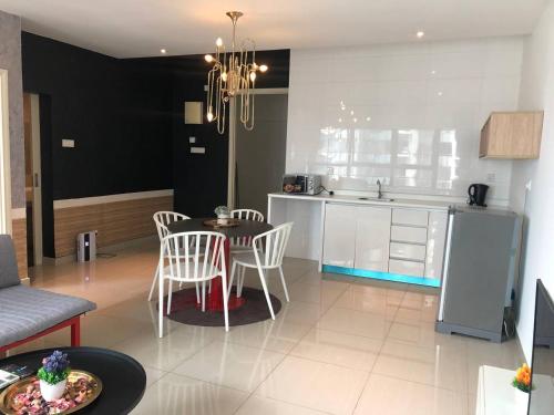 a kitchen and living room with a table and chairs at Arte Plus Jalan Ampang KLCC in Kuala Lumpur