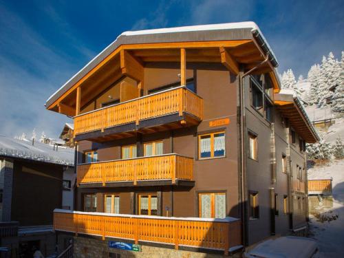 a building with balconies on the side of it at Chalet Diana - Spacious flat - Village core - South facing - Ski-in/Ski-out in Bettmeralp