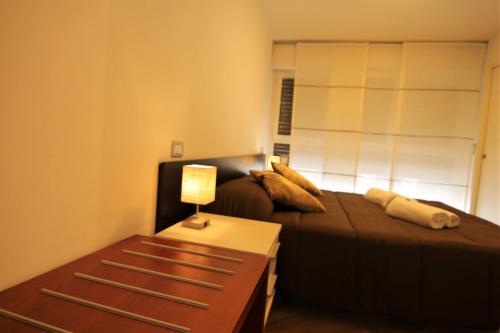 a bedroom with two beds and a table with a lamp at Fabrizi79 in Pescara