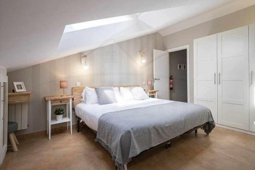 a bedroom with a large bed and a skylight at Balcón Indiano in Colombres