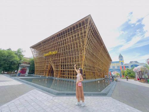 a woman standing in front of a large building at The Sol House in Phu Quoc