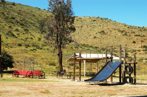 a playground with a slide and a slideintend at Pio Pico Camping Resort One-Bedroom Cabin 14 in Jamul