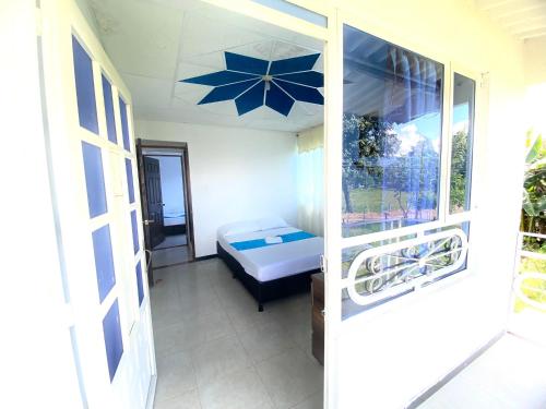 a view of a bedroom with a bed and an umbrella at La Morena Hospedaje in Acacías