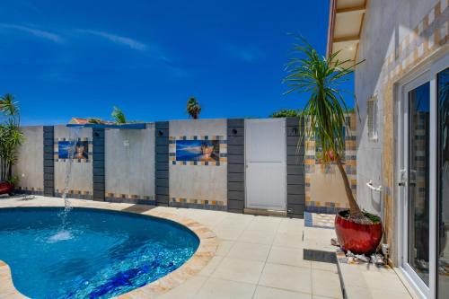 a swimming pool in front of a building at Boutique Hotel Swiss Paradise Aruba Villas and Suites in Palm-Eagle Beach
